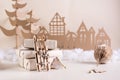 DIY Christmas home decor - wooden sledge near pile of gifts, cardboard tree and house. Handmade