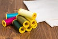DIY concept multicolor Sewing thread and needle on white wooden Royalty Free Stock Photo