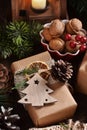 Creatively wrapped Christmas gift in rustic style on wooden table