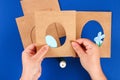 Diy Easter cards from paper. Volume greeting cards with a bunny, egg on blue background. 3d Royalty Free Stock Photo