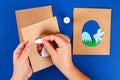 Diy Easter cards from paper. Volume greeting cards with a bunny, egg on blue background. 3d Royalty Free Stock Photo