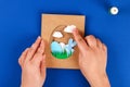 Diy Easter cards from paper. Volume greeting cards with a bunny, egg on blue background. 3d Royalty Free Stock Photo