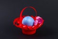 Diy Easter egg basket made of red plastic cup decorated with artificial flowers black background Royalty Free Stock Photo