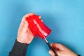 Diy Easter egg basket made of red plastic cup decorated with artificial flowers on blue background Royalty Free Stock Photo