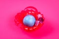 Diy Easter egg basket made of red plastic cup decorated with artificial flowers pink background Royalty Free Stock Photo