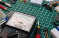 DIY electrical maker tools components on green cutting mat board.