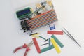 DIY electronics hobby kit opened heatshrink laying around on the grey background. DIY engineer electronic kit set. Royalty Free Stock Photo