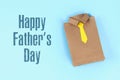 Diy fathers day gift bag package shirt with necktie crafting paper on a blue background Royalty Free Stock Photo