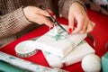 DIY Gift Wrapping. Unrecognisable woman wrapping beautiful nordic style christmas gifts.