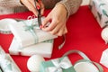 DIY Gift Wrapping. Unrecognisable woman wrapping beautiful nordic style christmas gifts.