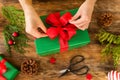 DIY Gift Wrapping. Woman wrapping beautiful christmas gifts on rustic wooden table. Overhead view christmas wrapping. Royalty Free Stock Photo