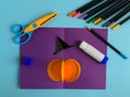 Diy Halloween card with pumpkin on purple background.Gift idea, decor Halloween.Instruction.Step by step.Top view. Children