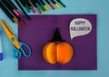 Diy Halloween card with pumpkin on purple background.Gift idea, decor Halloween.Instruction.Step by step.Top view. Children