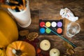 DIY Halloween concept. Art and craft, decorating Halloween pumpkins. Color pallete, paintbrush and pumpkins on a table. Royalty Free Stock Photo