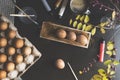 DIY hand painted easter eggs. Top view table top shot with eggs, paints, brushes and spring flowers Royalty Free Stock Photo