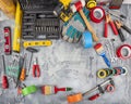 DIY and home improvement banner with work and construction tools on a wooden workbench top view, copy space at center. Royalty Free Stock Photo