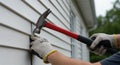 DIY Home Improvement: Installing Vinyl Siding with a Hammer Royalty Free Stock Photo