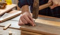 DIY, home repair and fixCarpenter nail wood. Male hand hold hammer and nail