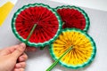 DIY instruction. Step by step tutorial. Making decor for summer birthday party - red and yellow watermelon fan. Craft Royalty Free Stock Photo