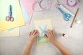 DIY and kids creativity. Step by step instruction: how to make card Happy easter. Step5 glue flower instead of rabbit tail. Royalty Free Stock Photo