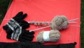 DIY knitting wool yarn, balls, knitting needles, and gloves. Royalty Free Stock Photo