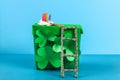 DIY leprechaun trap with gold coins, rainbow and green ladder St Patricks Day background Royalty Free Stock Photo