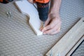 DIY moment detail indoors. Person following the steps to build a mdf wooden structure. Close-up image Royalty Free Stock Photo