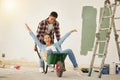DIY, painting and happy couple smile while moving into new home, real estate property house or building. Love, creative