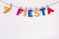 DIY paper Garland made of Fiesta word and sombrero. Fragment of festive decoration of interior. Cinco de mayo celebration