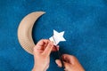 Diy Ramadan kareem crescent moon with a star from a disposable cardboard plate and gold paint