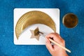 Diy Ramadan kareem crescent moon with a star from a disposable cardboard plate and gold paint