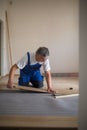 Senior landlord lying parquet floor board/laminate flooring in a rental appartement Royalty Free Stock Photo