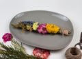 DIY smudge stick to banish bad energy. Dried herbs and flowers are tied into a bundle with a thread. Homemade incense