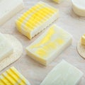 DIY soaps. Many various white homemade bar soaps. Handmade yellow colorful soap, spa bath products for body spa skin Royalty Free Stock Photo