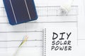 DIY solar power written on a notepad in a conceptual image of do it yourself home solar power system install