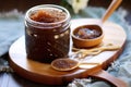 diy sugar scrub in a jar with wooden spoon