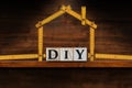 DIY Text made of Wooden Blocks and Folding ruler in the Shape of a House Royalty Free Stock Photo