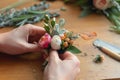 diy tutorial scene of making a silk flower boutonniere on a worktable