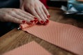 DIY wax candle making process. Woman making decorative wax candle, close-up of hands.