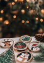 Diy wooden christmas ornaments on table in front of christmas tree Royalty Free Stock Photo