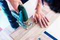 DIY worker cutting wooden panel with jig saw Royalty Free Stock Photo