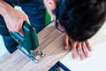 DIY worker cutting wooden panel with jig saw Royalty Free Stock Photo