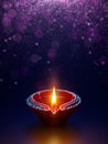 Diya lamp with glitter light background