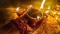 Diya Lamps Hold In The Hand. Dark And Blurry Diwali Night. Royalty Free Stock Photo