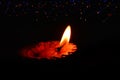 diya,lighting background and lamp,Happy Diwali - Lit diya lamp on street at night,Diya lamps lit on colorful light during Diwali