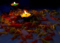 Diya placed on table with flowers for pooja