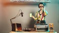 DJ artist shows greenscreen template while she uses turntables