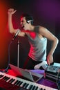 Dj with colorful light and music mixing equipment Royalty Free Stock Photo