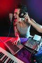 Dj with colorful light and music mixing equipment Royalty Free Stock Photo