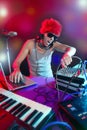 Dj with colorful light and music mixing equipment Royalty Free Stock Photo